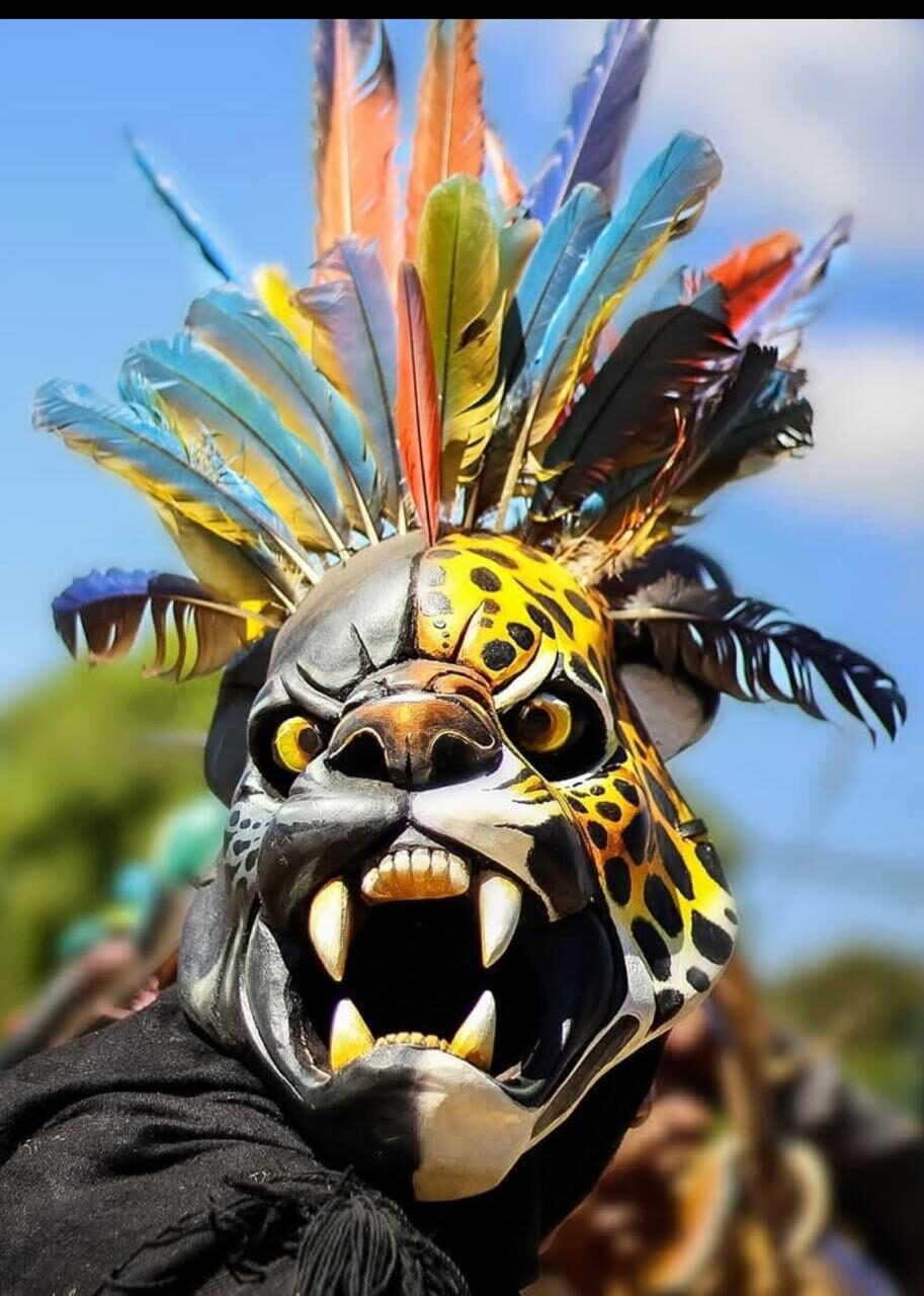 Boruca dancer in a feathered jaguar mask