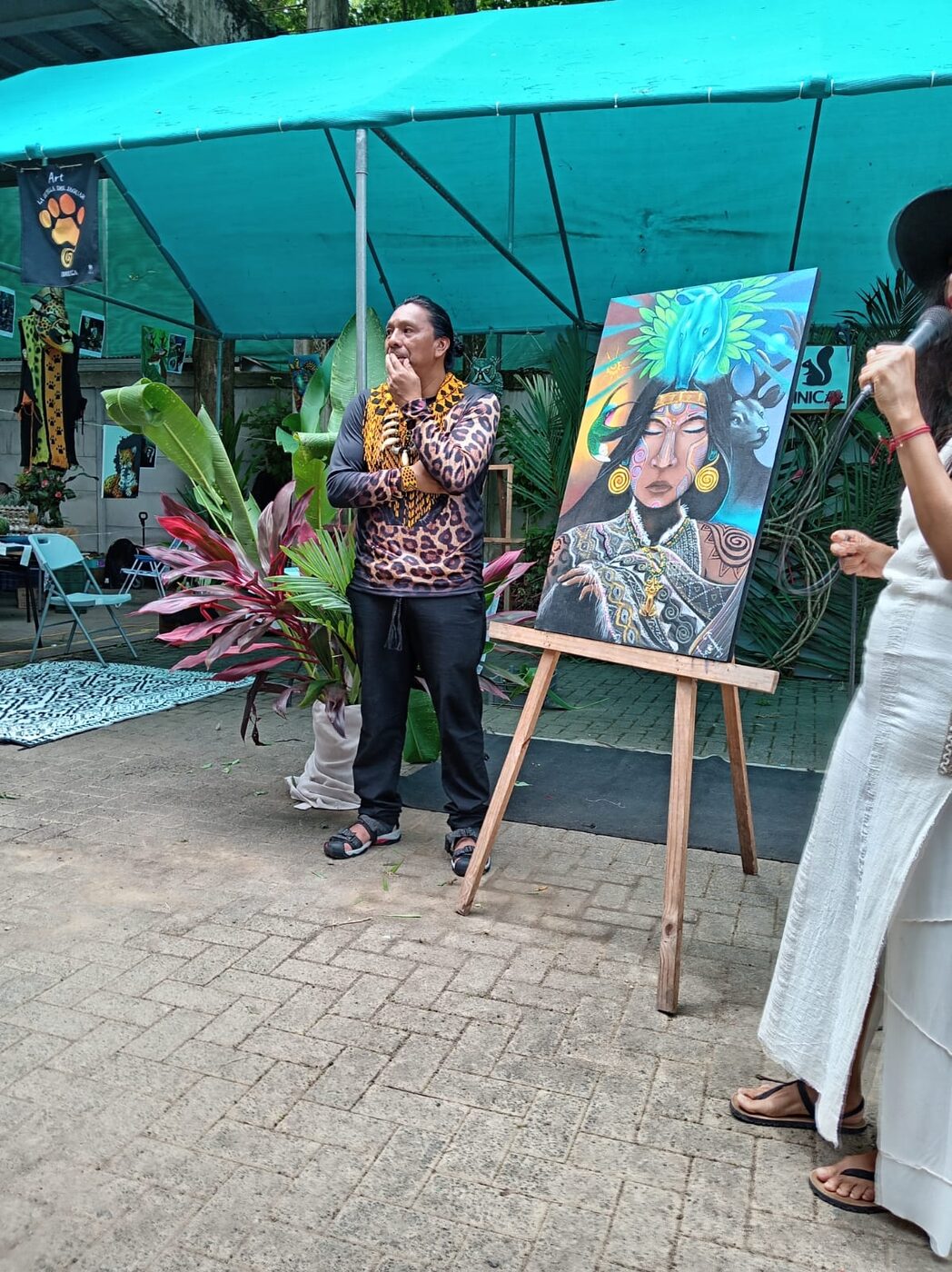 Kamel presenting a painting at an event