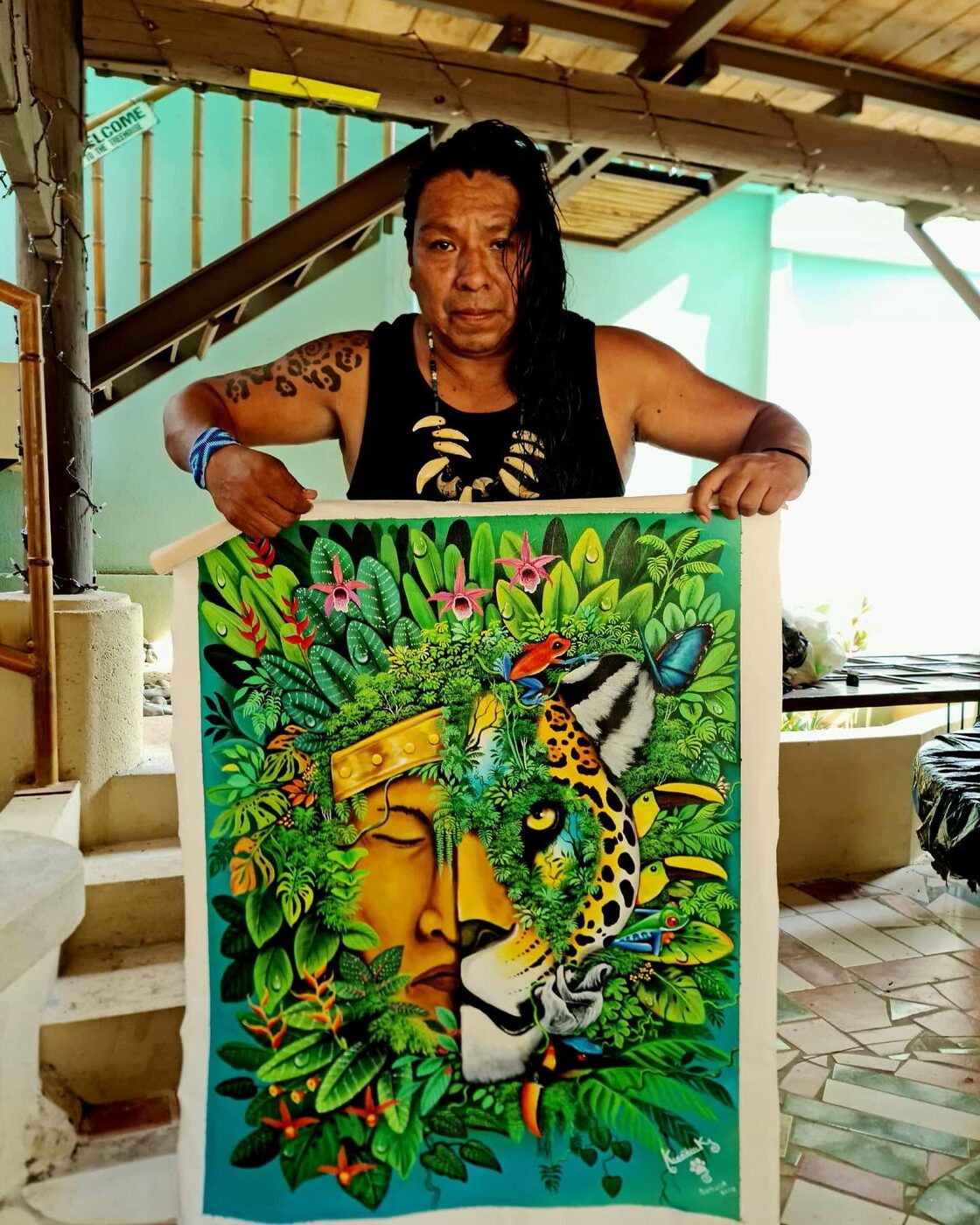 Kamel holding one of his jaguar paintings