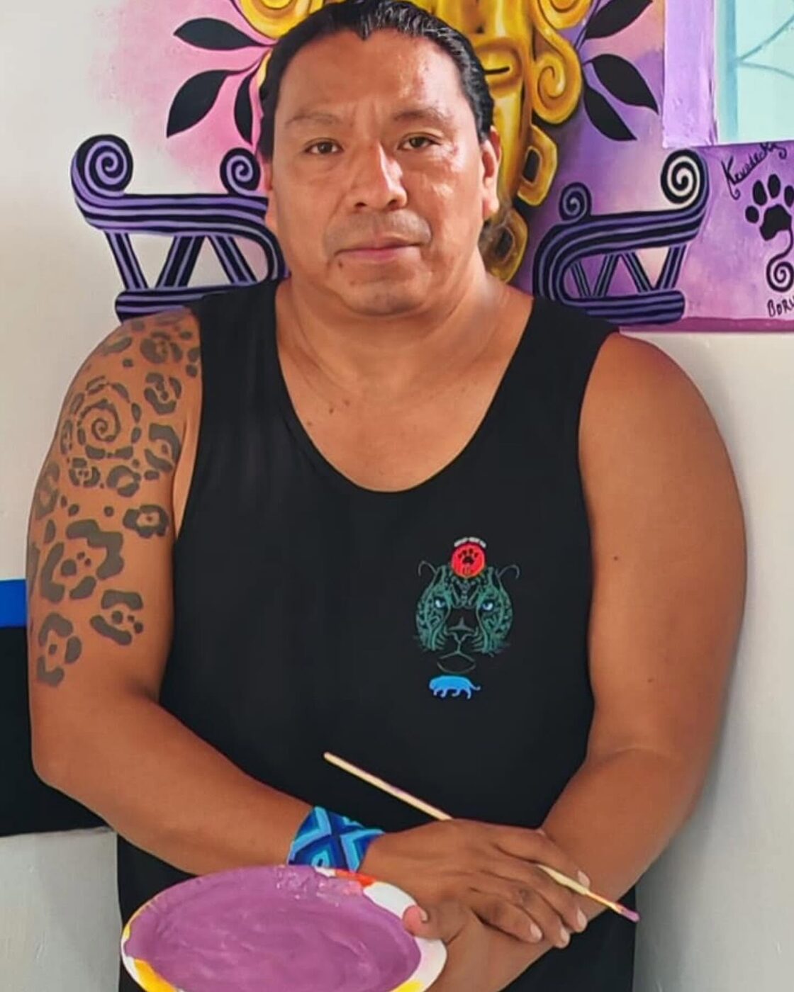 Kamel painting at his table in Boruca